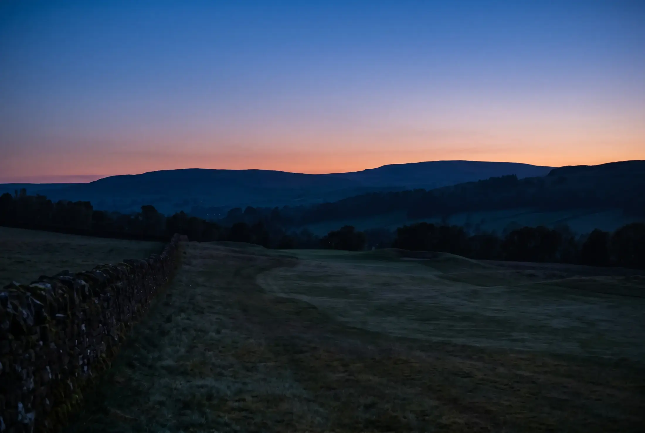 Dusk over the valley, the last colour draining from the sky above the hills